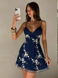 Back view of pink floral embroidered spaghetti strap mini dress with thin straps