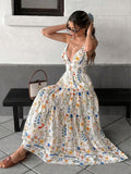White multicolor floral spaghetti strap cutout tiered maxi dress, seated view