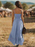 Back view of light blue smocked spaghetti strap dress with long ruffle hem