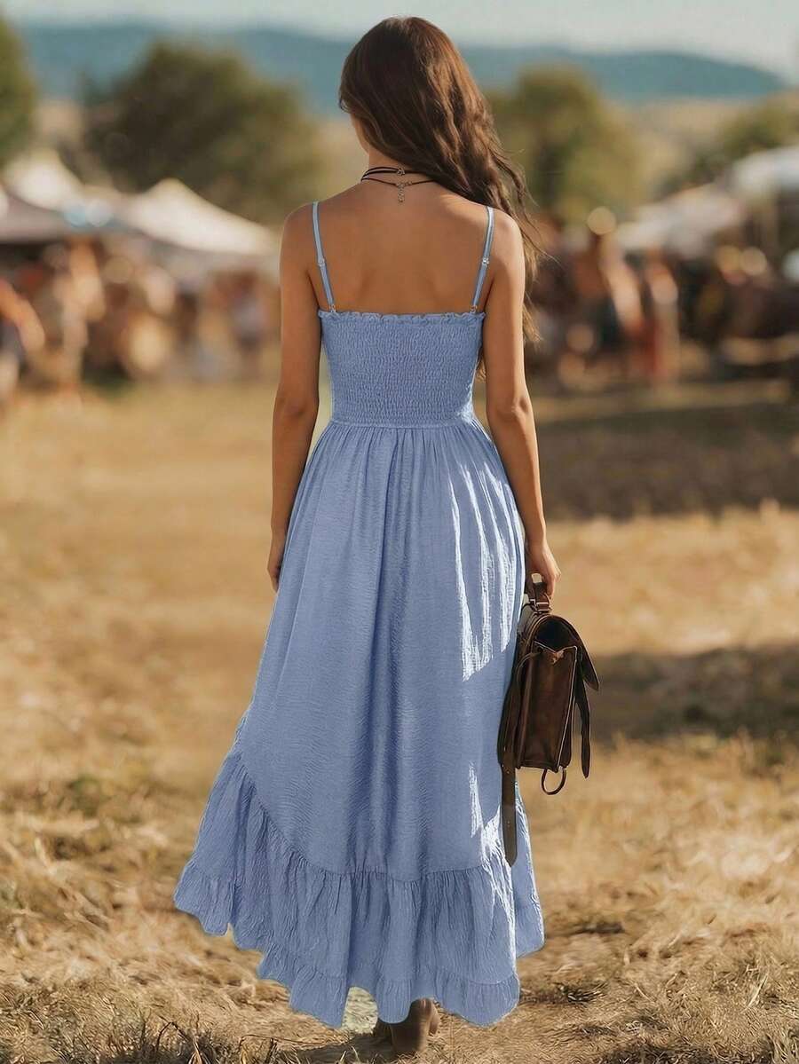 Back view of light blue smocked spaghetti strap dress with long ruffle hem