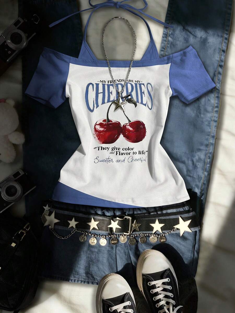 Front flat lay of white and blue off-shoulder halter top with cherry graphic and denim styling