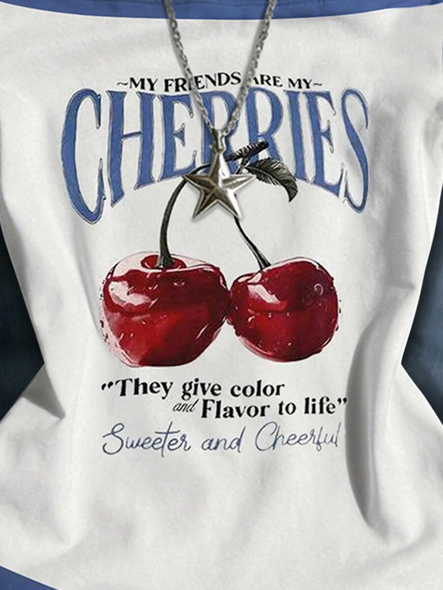 Close-up of cherry graphic on white and blue halter top with necklace detail