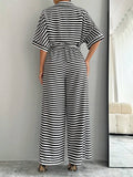 Styled view of striped belted wide-leg jumpsuit showing visible color, print, and silhouette