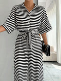 Styled view of striped belted wide-leg jumpsuit showing visible color, print, and silhouette