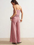 Back view of dusty pink strapless jumpsuit with rear pockets and long vertical seams