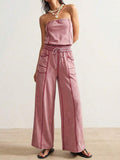Front view of dusty pink strapless wide-leg jumpsuit with drawstring waist and patch pockets