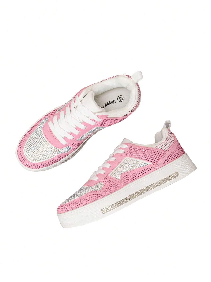 Overhead angled view of pink crystal-covered platform sneakers with white lining