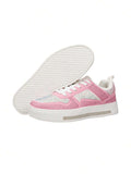 Side and outsole view of pink rhinestone sports shoes showing textured white tread
