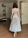 Back view of cream polka dot one shoulder maxi dress