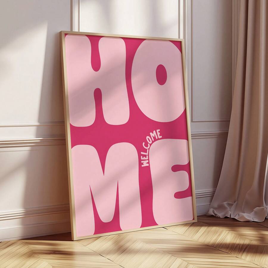 Natural wood framed pink Welcome Home poster beside a sunlit curtain and paneled wall