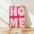 Frontal view of pink Welcome Home bubble typography wall art in a brown wood frame
