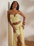 Front full view of light yellow ruched bandeau top and high-slit mesh maxi skirt two-piece set for beach vacation styling