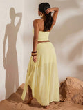 Back view of light yellow mesh bandeau crop top and flowing high-slit maxi skirt two-piece set for beach vacation styling