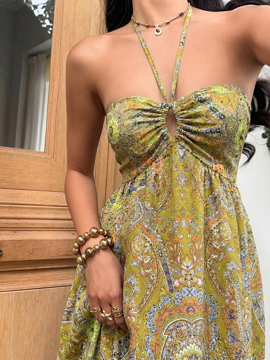 Close-up olive paisley halter dress with ruched sweetheart bust and keyhole