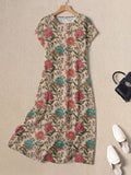 Flatlay of beige botanical maxi dress with black bag and white mules
