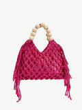 Hot pink crochet hollow beach bag with cream bead handle and side tassels