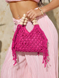 Hot pink crochet beach bag with cream bead handle and long side fringe