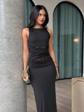 Three quarter front view of black bodycon maxi dress with sheer lace waist cutouts