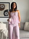 Front standing view of pink crinkle striped cami and relaxed pants outfit set
