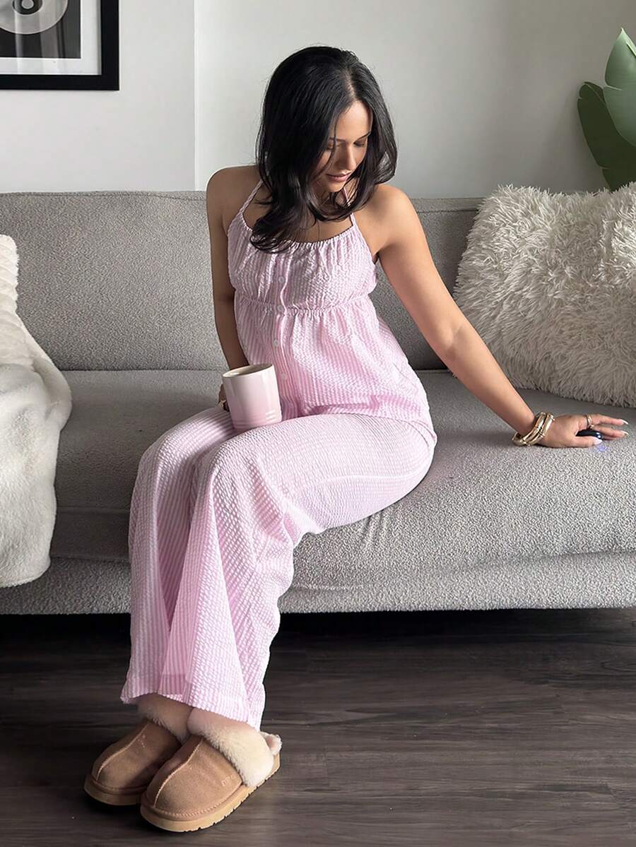 Front seated view of pink striped cami top and wide leg pants lounge set