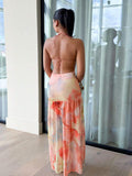 Back full body view of coral floral two piece skirt set with tie back cami top