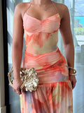 Close up front view of coral floral ruched cami top and low waist maxi skirt