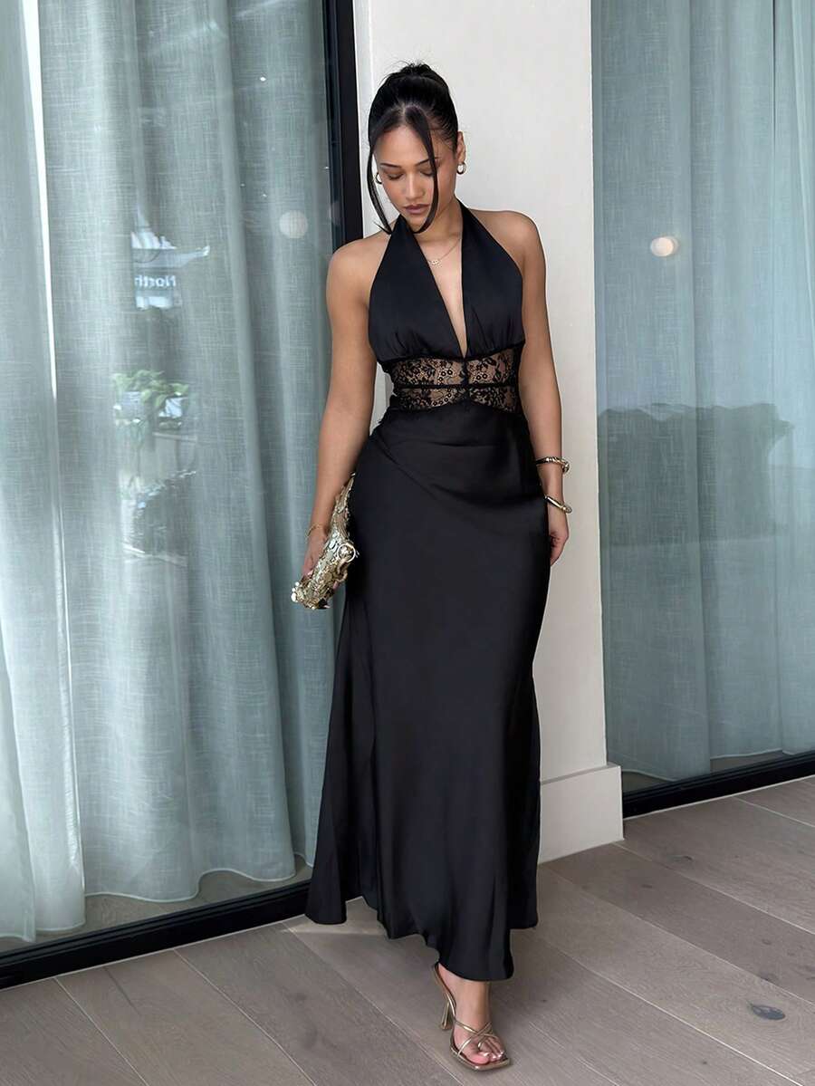 Front view of black halter satin maxi dress with plunging neckline and lace waist insert