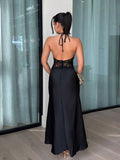 Back view of black halter maxi dress with open back tie and center zipper seam