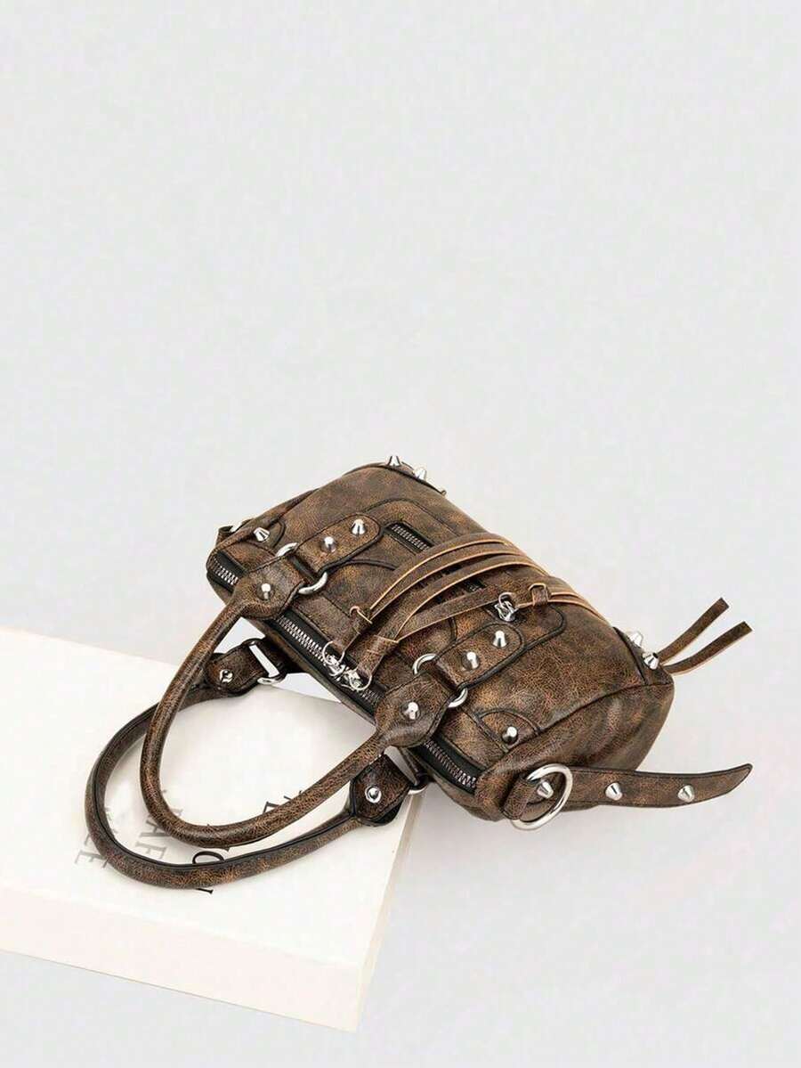 Sleek motorcycle-inspired crossbody bag designed for the modern woman on the move. Features a structured silhouette with adjustable shoulder strap for versatile wear—wear it crossbody for hands-free convenience or over your shoulder for classic style. Durable construction with multiple compartments keeps essentials organized. Perfect for daily commutes, weekend outings, or travel. Compact yet spacious, this fashion-forward bag combines edgy aesthetics with practical functionality.