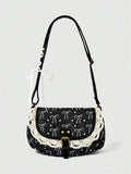 Black corduroy bow print shoulder bag with cream lace trim and buckle strap