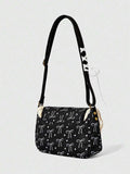 Back view of black bow print shoulder bag with adjustable strap