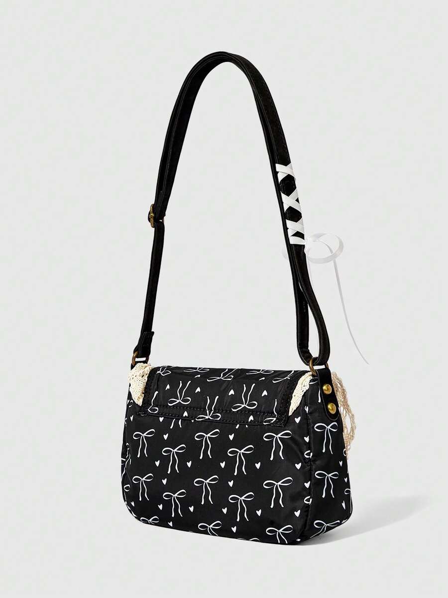 Back view of black bow print shoulder bag with adjustable strap