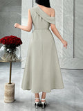 Back view of sage green asymmetric A-line midi dress with diagonal shoulder band in marble interior