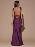 Back view of blue sleeveless deep V-neck maxi dress with crossed open back, shown for wedding and evening wear