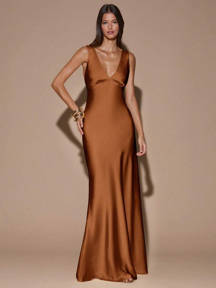 Back view of teal blue sleeveless deep V-neck maxi dress with crossed open back, shown for wedding and evening wear