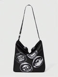 Lifestyle view of black graphic crossbody tote bag