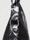 Detail view of black lip print bag with adjustable strap and metal buckle