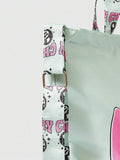 Lifestyle view of mint graphic tote bag worn on shoulder