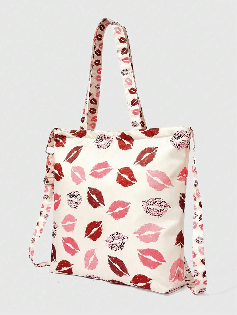 Detail view of cream graphic tote showing printed fabric strap and metal buckle