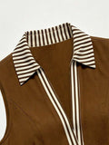 Close detail of brown shirt dress with striped collar and sleeveless armhole