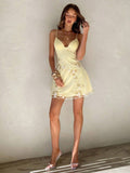 Back view of baby blue floral embroidered spaghetti strap mini dress with low zipper back