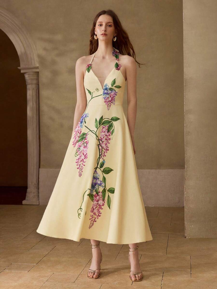 Close-up front view of pale yellow floral halter midi dress with appliqué straps and illusion V-neck