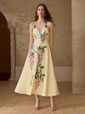 Full front view of pale yellow floral halter midi dress with fitted waist and flared tea-length skirt