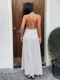 Capture effortless elegance with this blue plaid halter maxi dress, designed to blend classic charm with modern sophistication.