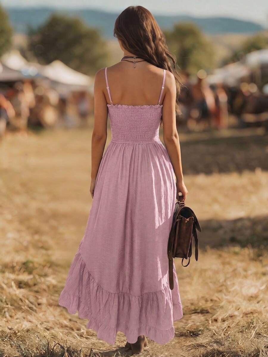 Back view of pink spaghetti strap dress with smocked back and tiered hem