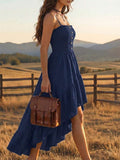 Back view of cream spaghetti strap dress with smocked back and long ruffle hem