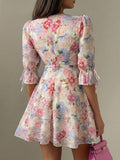 Close detail view of pastel floral V neck puff sleeve mini dress showing visible color, print, and silhouette