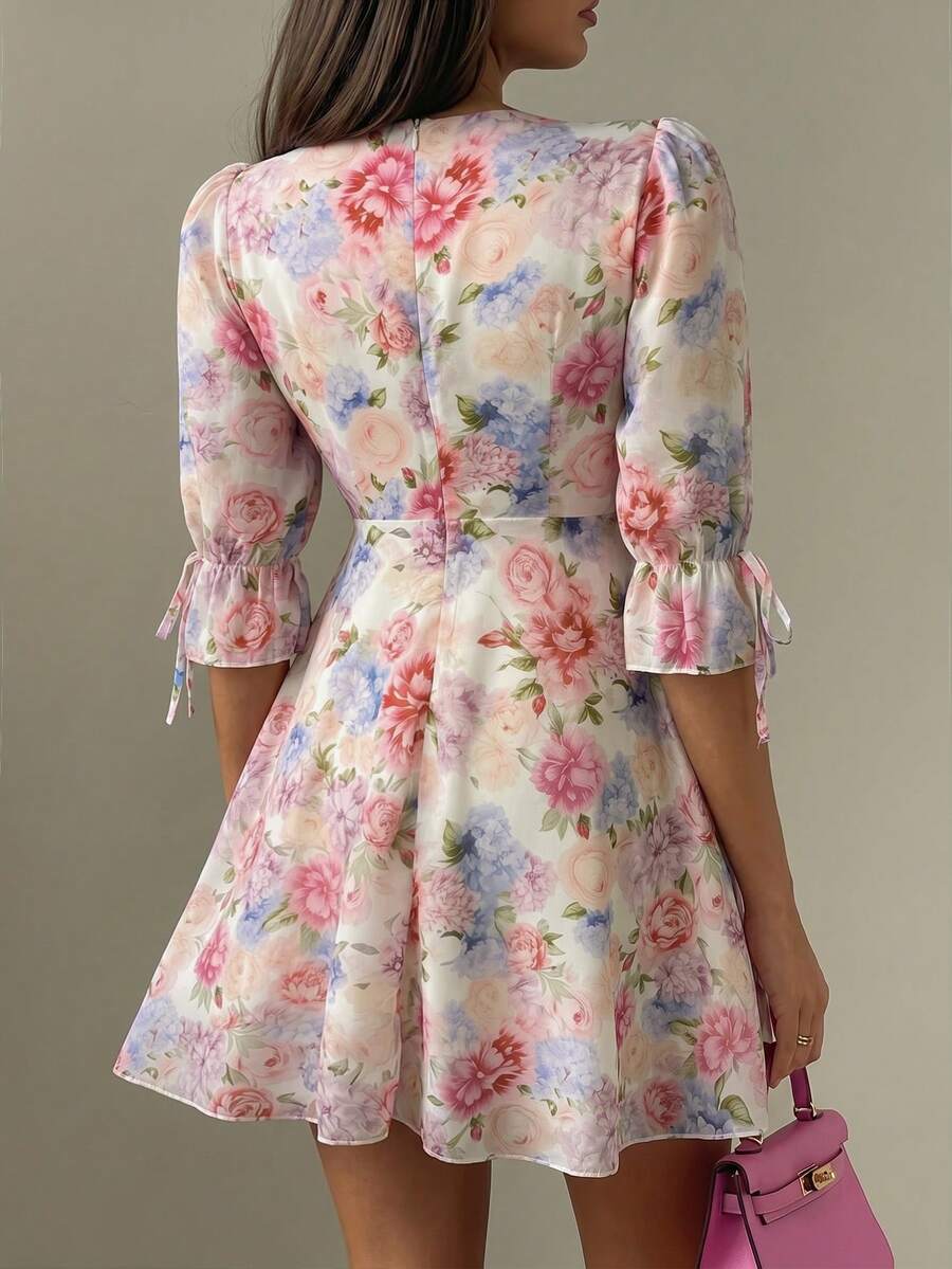 Close detail view of pastel floral V neck puff sleeve mini dress showing visible color, print, and silhouette