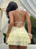 Styled view of shell trim halter ruffle mini dress showing visible color, trim, and silhouette
