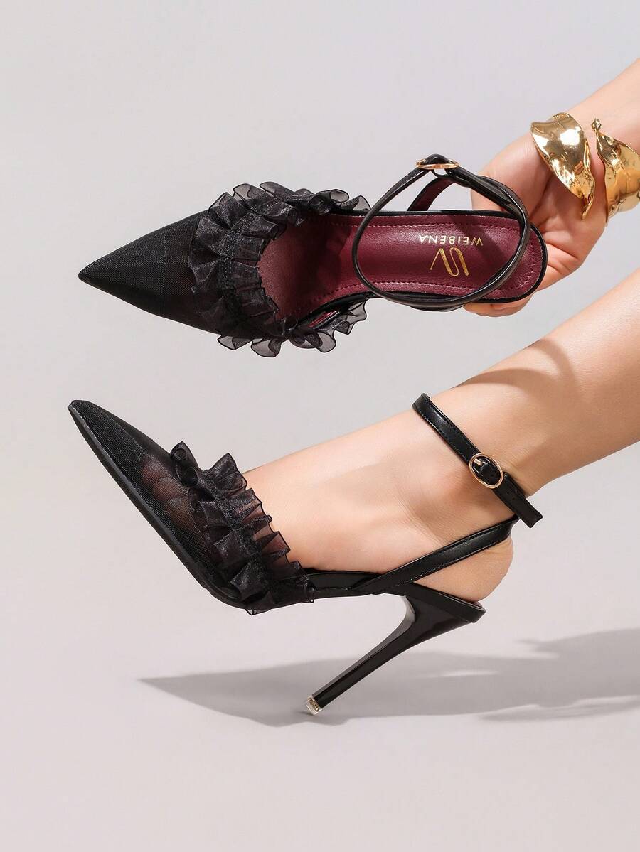 6 media show black pointed toe slingback stiletto heels with sheer mesh toe, organza ruffle frill across vamp, ankle strap, slingback strap, small round gold buckle, burgundy insole and thin dress sole. image 5